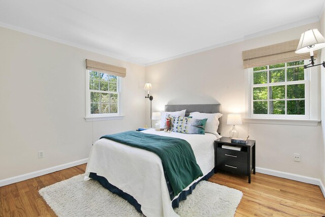151 Woodridge Dr, New Canaan, CT 06840 - bedroom with ornamental molding, baseboards, and wood finished floors