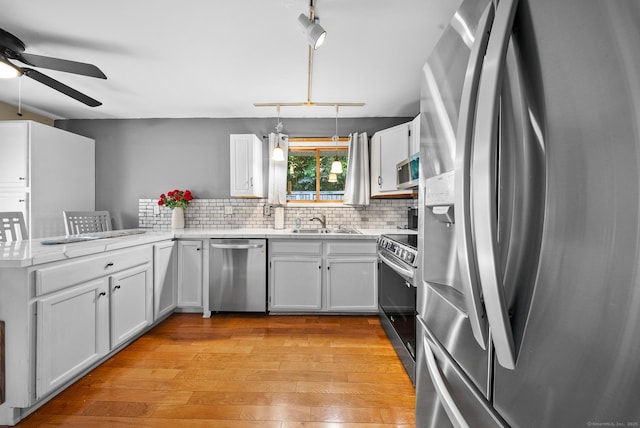 3 Celentano Dr, Naugatuck, CT 06770 - kitchen with appliances with stainless steel finishes, a ceiling fan, a peninsula, light wood-style floors, and a sink