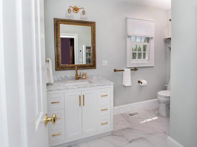 15 N Salem Rd, Ridgefield, CT 06877 - bathroom with marble look tiles, vanity, toilet, and baseboards