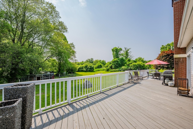 233 Church St, Hebron, CT 06231 - wooden deck featuring outdoor dining space, a lawn, area for grilling, and view of wooded area