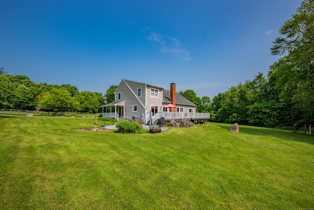 233 Church St, Hebron, CT 06231 - rear view of house featuring a chimney, a lawn, and a deck