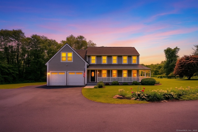 233 Church St, Hebron, CT 06231 - view of front of property with covered porch, driveway, a front yard, and an attached garage