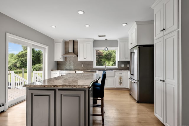 233 Church St, Hebron, CT 06231 - kitchen featuring freestanding refrigerator, wall chimney range hood, plenty of natural light, decorative backsplash, and recessed lighting
