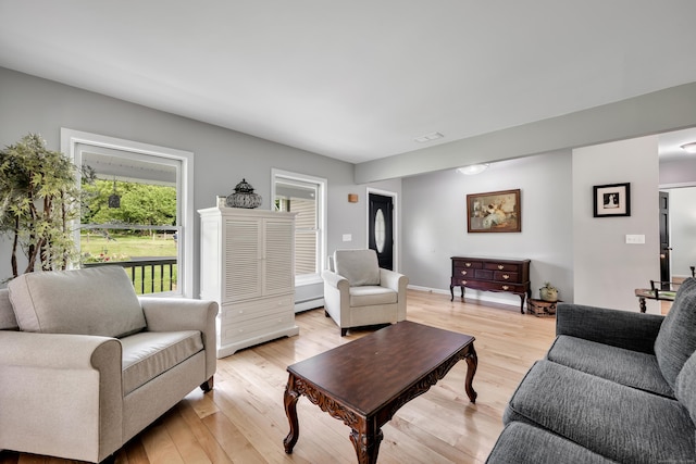 233 Church St, Hebron, CT 06231 - living area featuring light wood finished floors and a baseboard heating unit