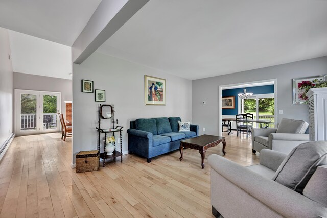 233 Church St, Hebron, CT 06231 - living room featuring healthy amount of natural light, a chandelier, light wood-style flooring, and baseboards