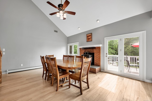 233 Church St, Hebron, CT 06231 - dining space featuring high vaulted ceiling, light wood-style floors, a brick fireplace, ceiling fan, and a baseboard heating unit