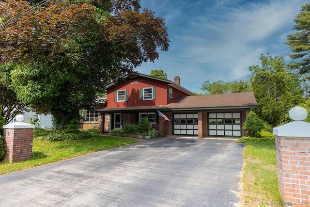 3 Glen Dr, Old Saybrook, CT 06475 - view of front of property with an attached garage, driveway, a chimney, and brick siding