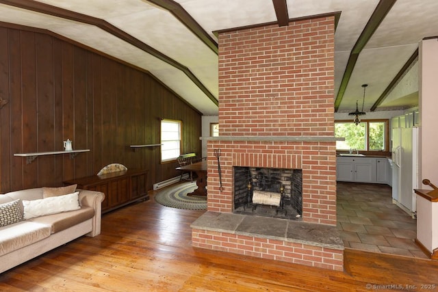 3 Glen Dr, Old Saybrook, CT 06475 - living area featuring healthy amount of natural light, a brick fireplace, wood finished floors, and wood walls