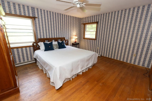 3 Glen Dr, Old Saybrook, CT 06475 - bedroom featuring baseboard heating, wood finished floors, and ceiling fan