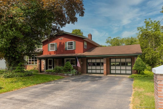 3 Glen Dr, Old Saybrook, CT 06475 - traditional home featuring brick siding, an attached garage, asphalt driveway, and a chimney