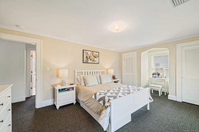 407 Meadowbrook Rd, Fairfield, CT 06824 - bedroom featuring dark colored carpet, multiple closets, baseboards, ornamental molding, and arched walkways