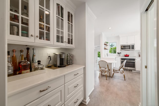407 Meadowbrook Rd, Fairfield, CT 06824 - bar area featuring stainless steel appliances, decorative backsplash, and recessed lighting