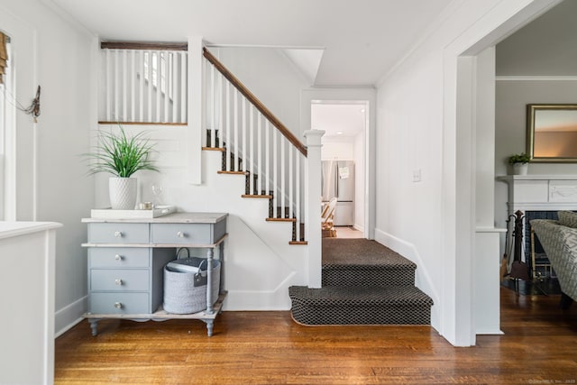 407 Meadowbrook Rd, Fairfield, CT 06824 - staircase with crown molding, wood finished floors, and baseboards