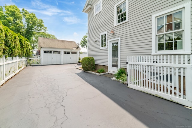 407 Meadowbrook Rd, Fairfield, CT 06824 - view of side of home with a detached garage and an outdoor structure
