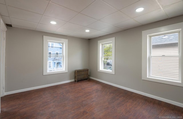 Pine St, Meriden, CT 06450 - unfurnished room featuring radiator heating unit, dark wood-style flooring, baseboards, a paneled ceiling, and recessed lighting