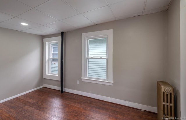Pine St, Meriden, CT 06450 - empty room with radiator heating unit, dark wood-style floors, baseboards, and recessed lighting