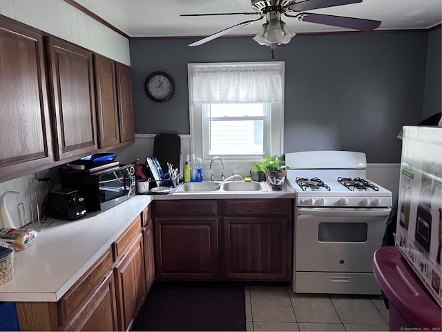 Pine St, Meriden, CT 06450 - kitchen featuring white range with gas stovetop, black microwave, a sink, ceiling fan, and light tile patterned flooring
