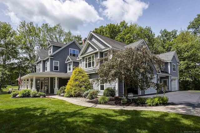112 John Hand Dr, Coventry, CT 06238 - view of front of house with a front lawn, covered porch, a shingled roof, a garage, and asphalt driveway