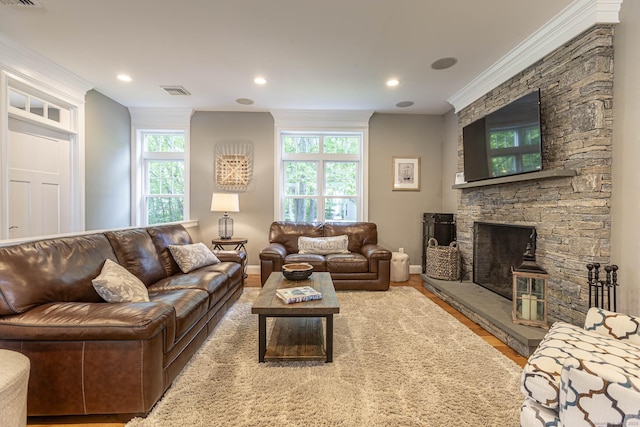 112 John Hand Dr, Coventry, CT 06238 - living area with crown molding, baseboards, a fireplace, wood finished floors, and recessed lighting