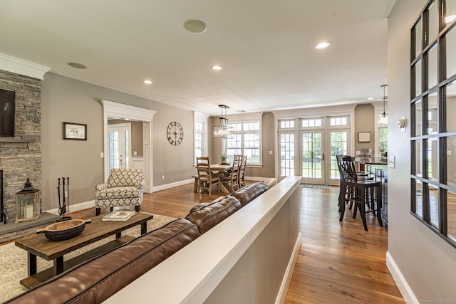 112 John Hand Dr, Coventry, CT 06238 - living area featuring hardwood / wood-style floors, baseboards, recessed lighting, a stone fireplace, and french doors