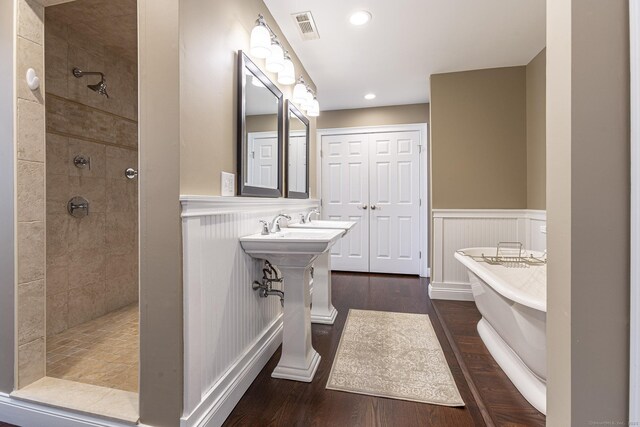 112 John Hand Dr, Coventry, CT 06238 - full bathroom with wainscoting, a soaking tub, a tile shower, wood finished floors, and recessed lighting