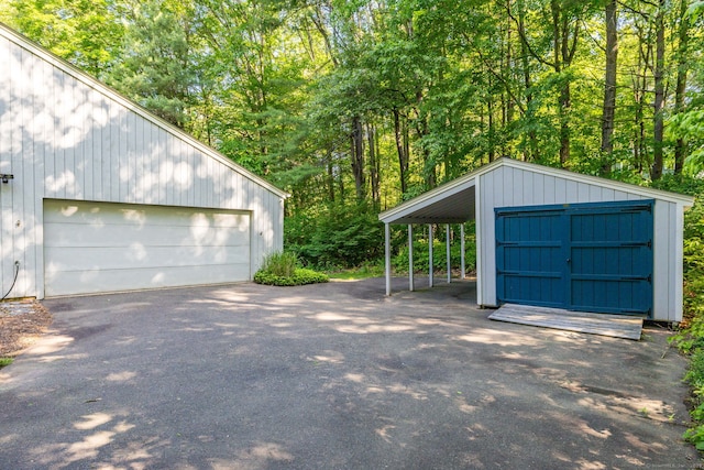 20 Roundhill Rd, Granby, CT 06035 - garage with a detached garage and a view of trees