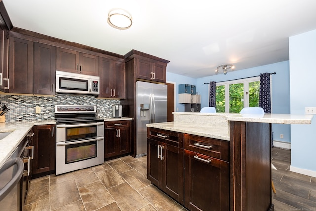 20 Roundhill Rd, Granby, CT 06035 - kitchen featuring appliances with stainless steel finishes, tasteful backsplash, dark brown cabinetry, and a baseboard radiator