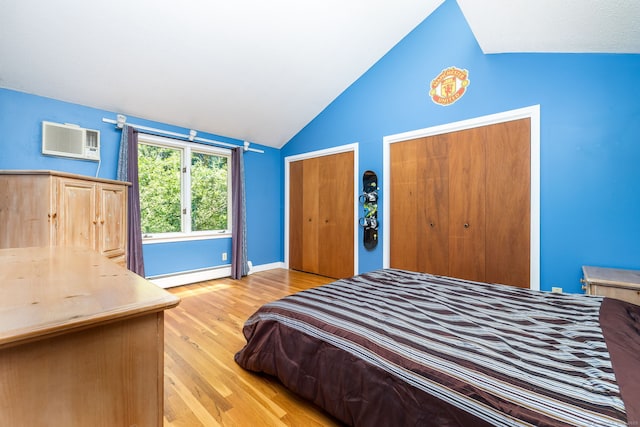 20 Roundhill Rd, Granby, CT 06035 - bedroom featuring vaulted ceiling, a baseboard radiator, wood finished floors, a wall mounted air conditioner, and two closets