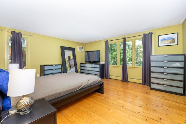 20 Roundhill Rd, Granby, CT 06035 - bedroom featuring an AC wall unit, baseboard heating, and wood-type flooring