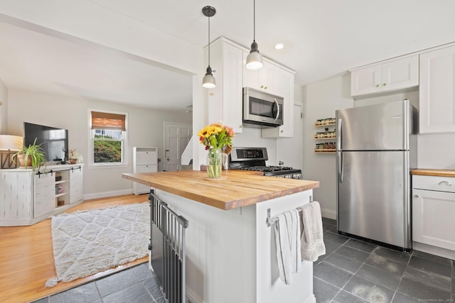 407 Sylvan Knoll Rd, Stamford, CT 06902 - kitchen featuring stainless steel appliances, wooden counters, white cabinets, hanging light fixtures, and baseboards