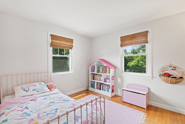 407 Sylvan Knoll Rd, Stamford, CT 06902 - bedroom featuring multiple windows, wood finished floors, and baseboards