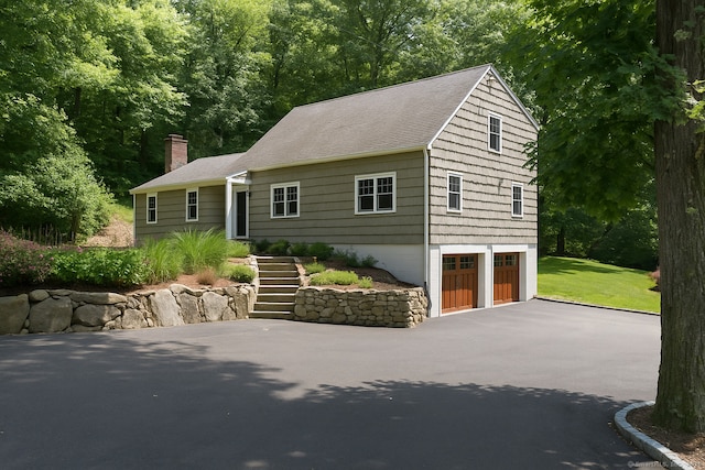 4 Berkeley Hl, Westport, CT 06880 - view of front facade featuring asphalt driveway, an attached garage, a chimney, stairway, and a shingled roof