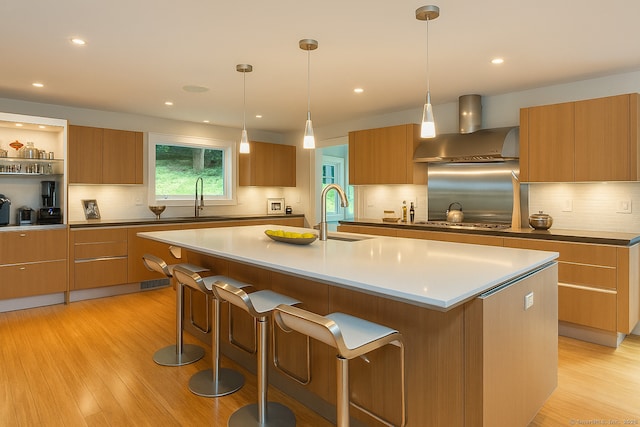 4 Berkeley Hl, Westport, CT 06880 - kitchen with wall chimney range hood, modern cabinets, a sink, and recessed lighting