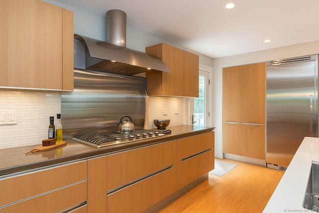 4 Berkeley Hl, Westport, CT 06880 - kitchen featuring wall chimney exhaust hood, stainless steel appliances, light wood finished floors, decorative backsplash, and recessed lighting