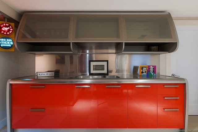 4 Berkeley Hl, Westport, CT 06880 - kitchen with red cabinetry, stainless steel counters, and modern cabinets