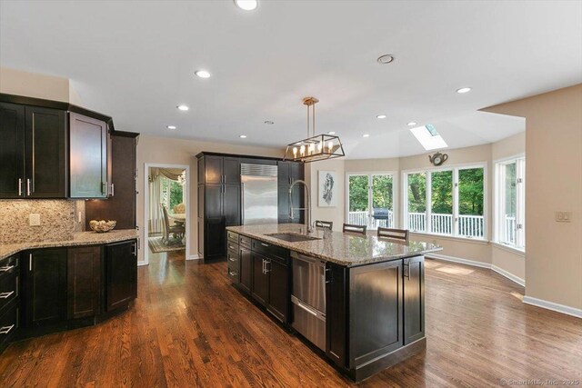 1 Mountaincrest Dr, Cheshire, CT 06410 - kitchen with a sink, a skylight, light stone countertops, stainless steel built in fridge, and recessed lighting