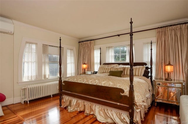 262 Kenyon St, Hartford, CT 06105 - bedroom with radiator, a wall mounted air conditioner, wood finished floors, and crown molding