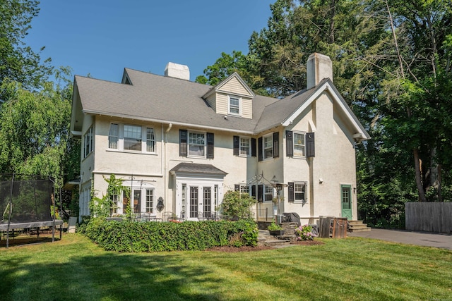262 Kenyon St, Hartford, CT 06105 - rear view of property with a trampoline, a chimney, stucco siding, and french doors