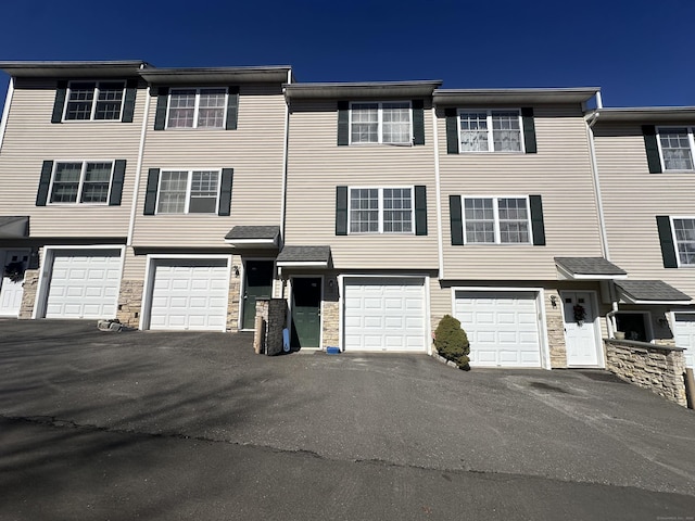 135 Bucks Hill Rd Apt 10, Waterbury, CT 06704 - view of property with an attached garage, driveway, and stone siding