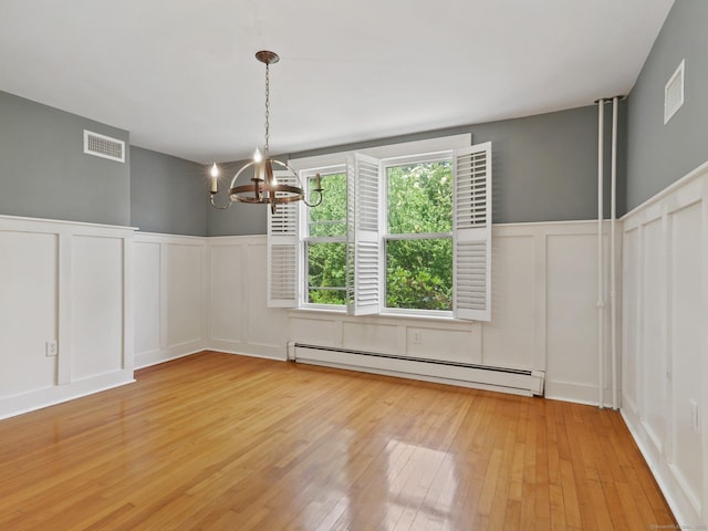 355 Main St, Old Saybrook, CT 06475 - unfurnished dining area with baseboard heating, a decorative wall, a chandelier, light wood-type flooring, and a wainscoted wall