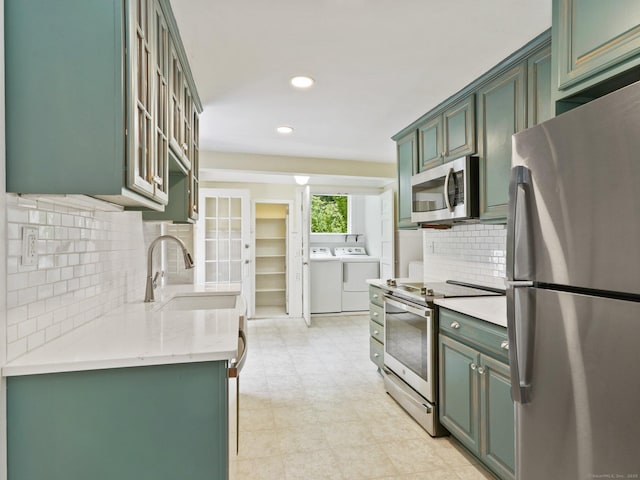 355 Main St, Old Saybrook, CT 06475 - kitchen featuring stainless steel appliances, washing machine and clothes dryer, green cabinetry, recessed lighting, and decorative backsplash
