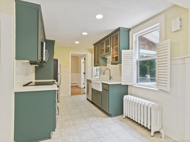 355 Main St, Old Saybrook, CT 06475 - kitchen featuring radiator, green cabinets, wainscoting, light countertops, and baseboard heating