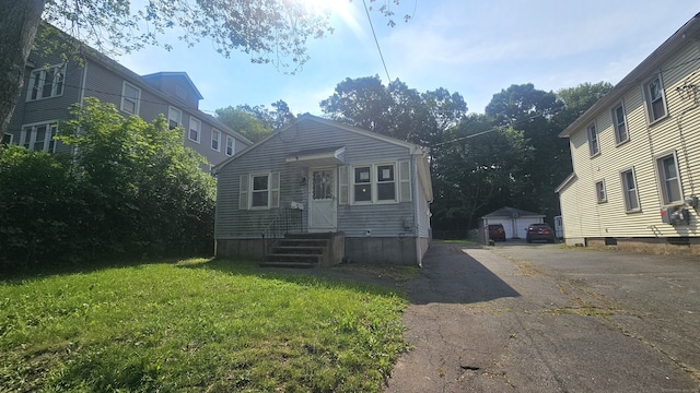 215 Stanley St, New Britain, CT 06051 - view of front of home featuring an outbuilding and a front lawn
