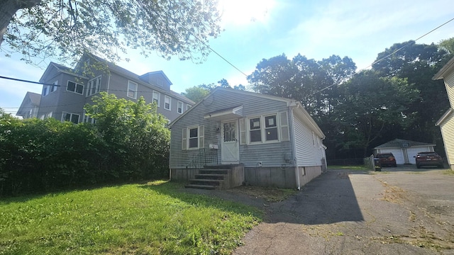 215 Stanley St, New Britain, CT 06051 - view of front facade featuring a front yard, driveway, and an outdoor structure