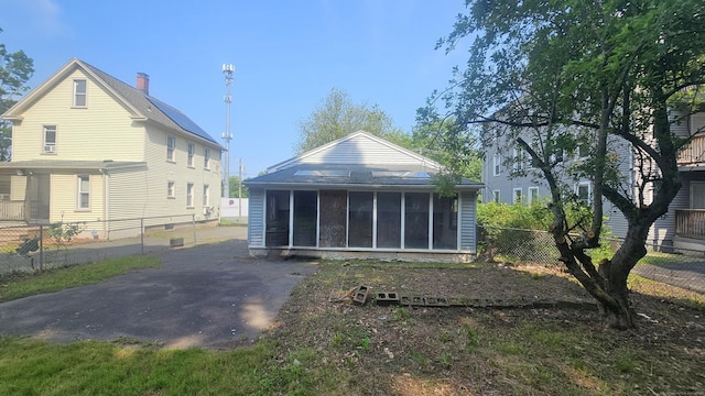 215 Stanley St, New Britain, CT 06051 - rear view of property featuring a sunroom and a chimney