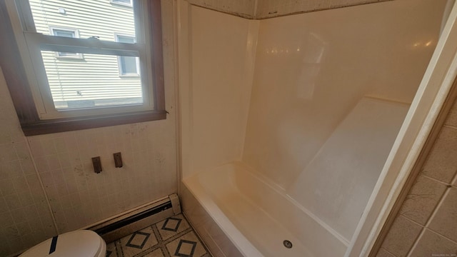 215 Stanley St, New Britain, CT 06051 - bathroom featuring toilet, a baseboard radiator,  shower combination, tile patterned floors, and tile walls