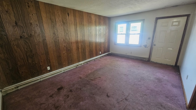 215 Stanley St, New Britain, CT 06051 - empty room featuring wooden walls, carpet flooring, a textured ceiling, and baseboards