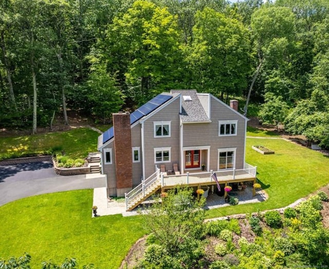 2 Pent Rd, Bloomfield, CT 06002 - back of house with a deck, roof mounted solar panels, a lawn, a chimney, and stairway