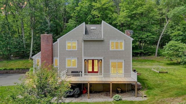 2 Pent Rd, Bloomfield, CT 06002 - rear view of property featuring a chimney, a deck, a shingled roof, a lawn, and a view of trees