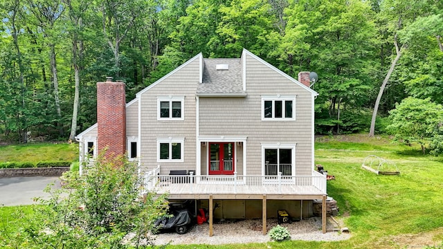 2 Pent Rd, Bloomfield, CT 06002 - back of property with a chimney, a wooden deck, a yard, roof with shingles, and a wooded view
